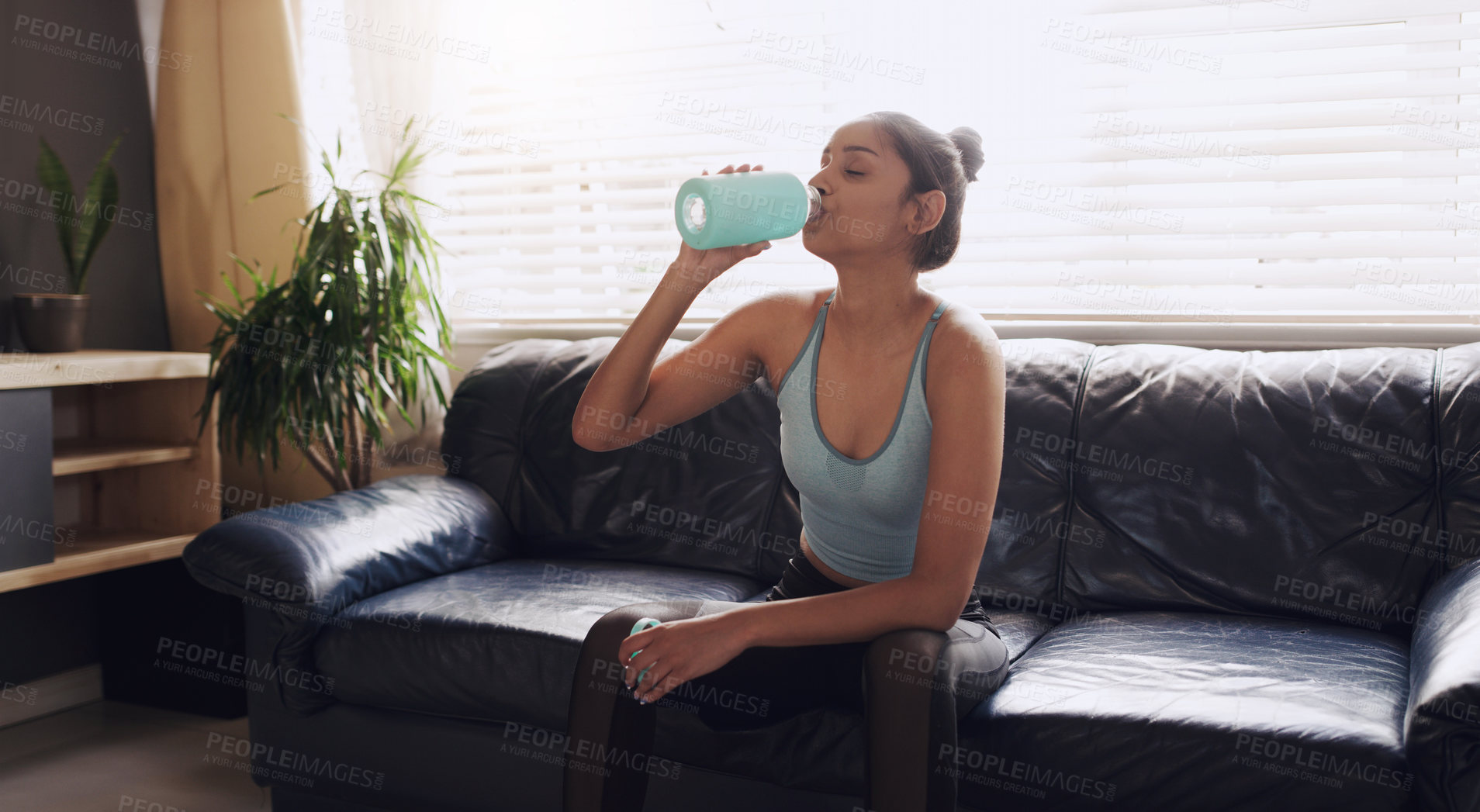 Buy stock photo Home, fitness and woman drinking water on a sofa after yoga, training or cardio in her house. Hydration, break and female person thirsty in a living room after meditation, exercise or body workout