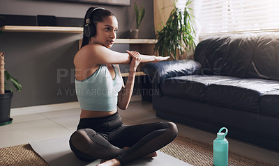 Buy stock photo Shot of a young female fitness trainer getting ready to live stream her workout at home
