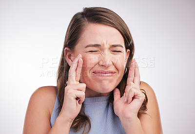 Buy stock photo Woman, fingers crossed for wish or hope with praying, superstition or faith for success on white background. Body language, communication and sign for optimism, emoji and facial expression in studio