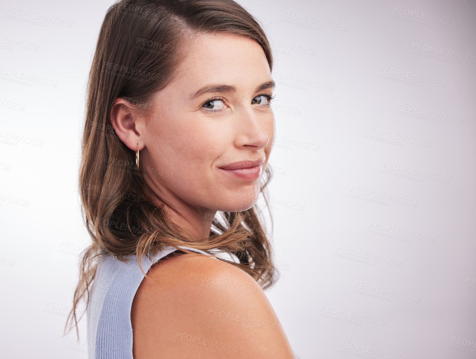 Buy stock photo Studio portrait of a confident young woman posing against a grey background