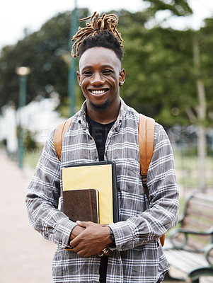 Buy stock photo Shot of a young man holding books on campus