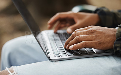 Buy stock photo Cropped shot of a man using a laptop on campus