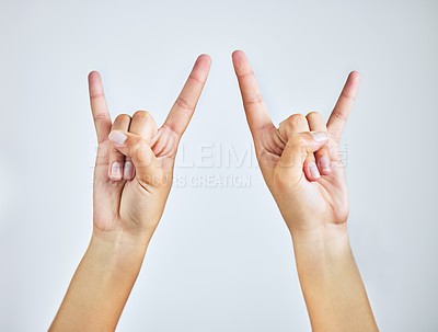 Buy stock photo Hands, closeup and person in studio with rock and roll sign, gesture or symbol on white background. Zoom, rebel and icon with rocker emoji for edgy, cool or contemporary, metal or punk aesthetic