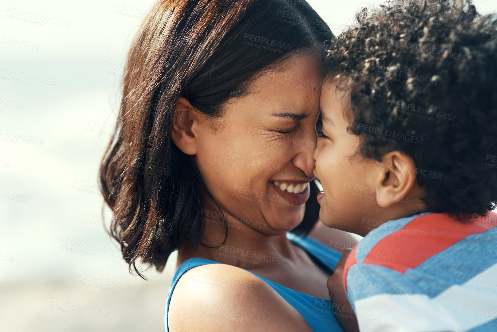 Buy stock photo Shot of a mother and son being affectionate on the beach
