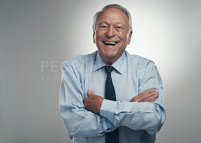 Buy stock photo Shot of a senior businessman standing alone against a grey background in the studio with his arms crossed