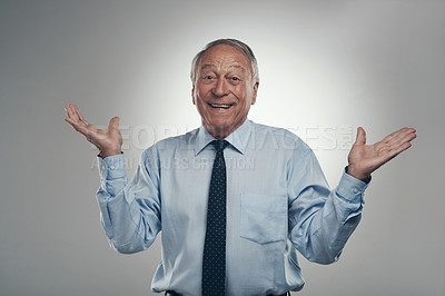 Buy stock photo Shot of a senior businessman standing against a grey background in the studio and making a choice between two options