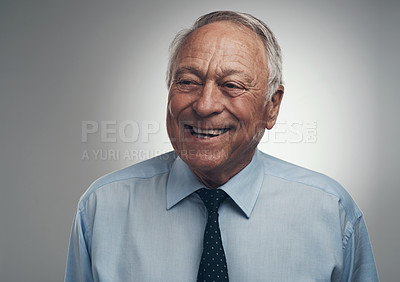 Buy stock photo Shot of a senior businessman standing alone against a grey background in the studio during the day