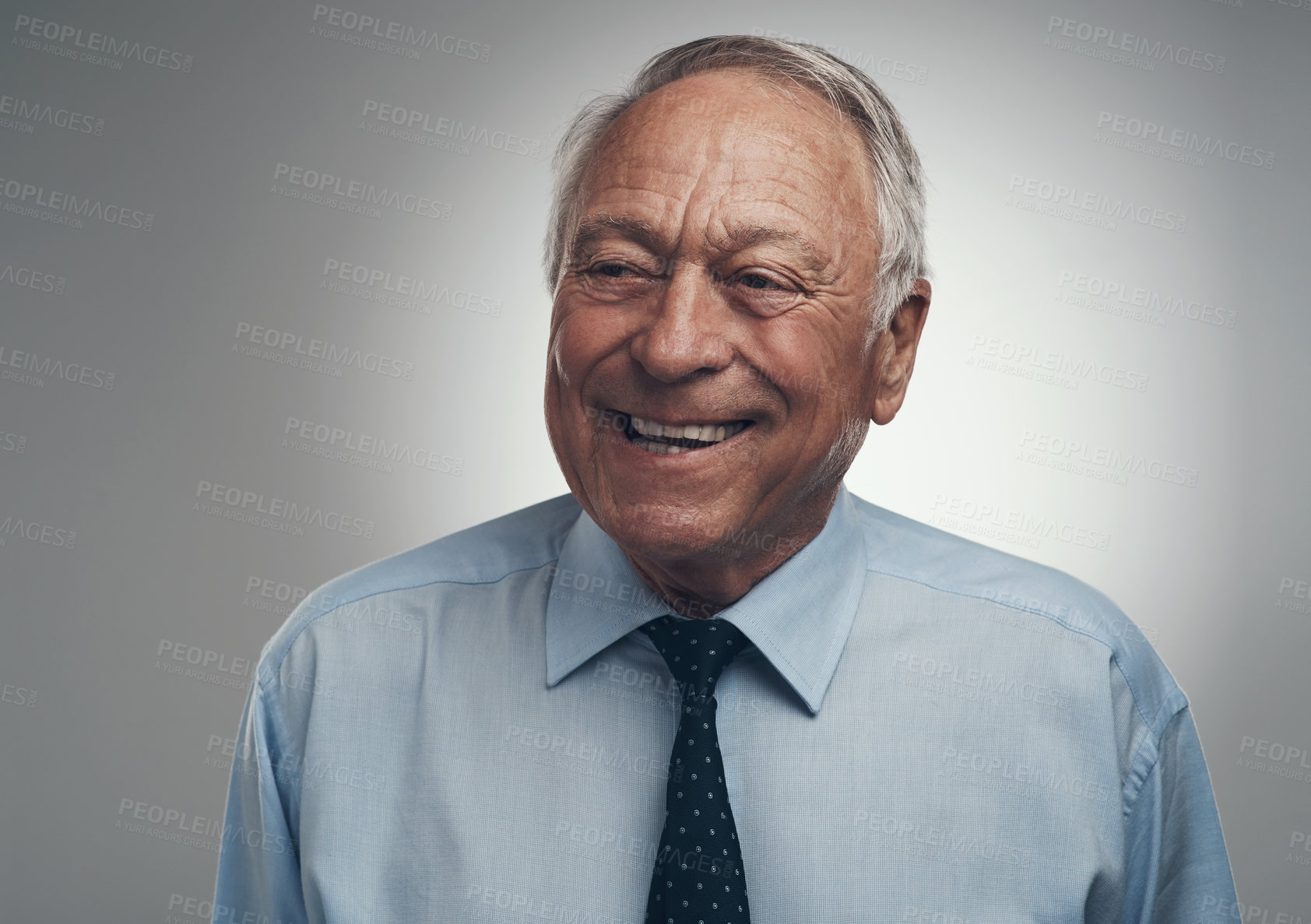 Buy stock photo Shot of a senior businessman standing alone against a grey background in the studio during the day