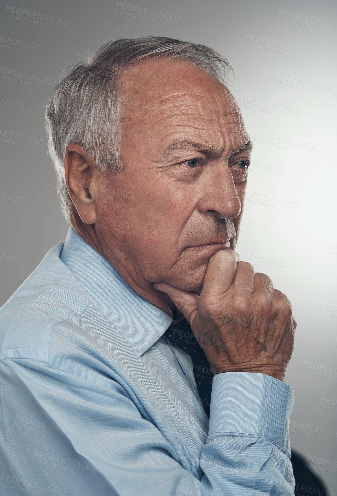 Buy stock photo Shot of a senior businessman standing alone against a grey background in the studio and looking contemplative