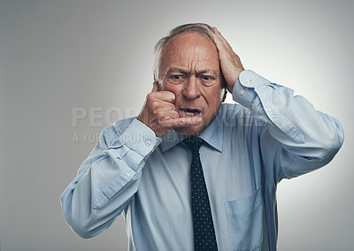 Buy stock photo Shot of a senior businessman standing alone against a grey studio background and making a cellphone hand gesture