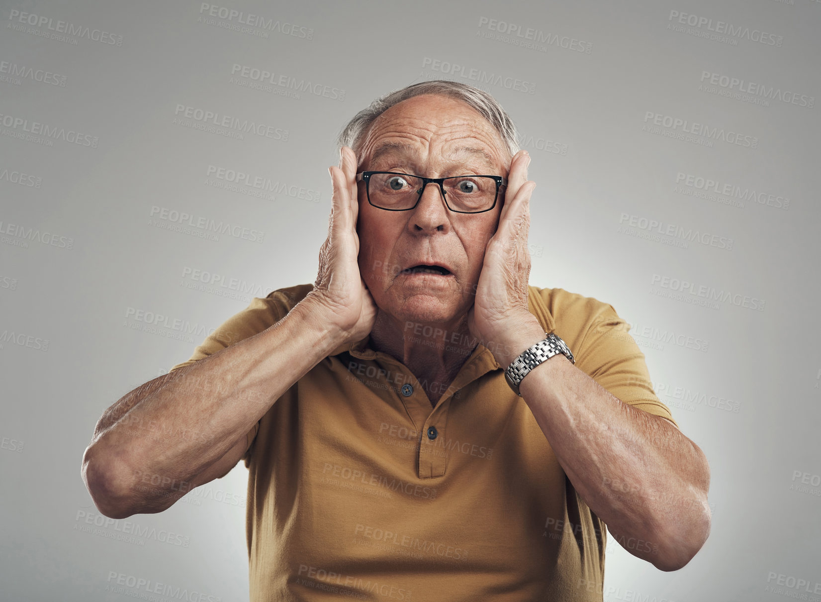 Buy stock photo Studio shot of an elderly man getting a big shock against a grey background