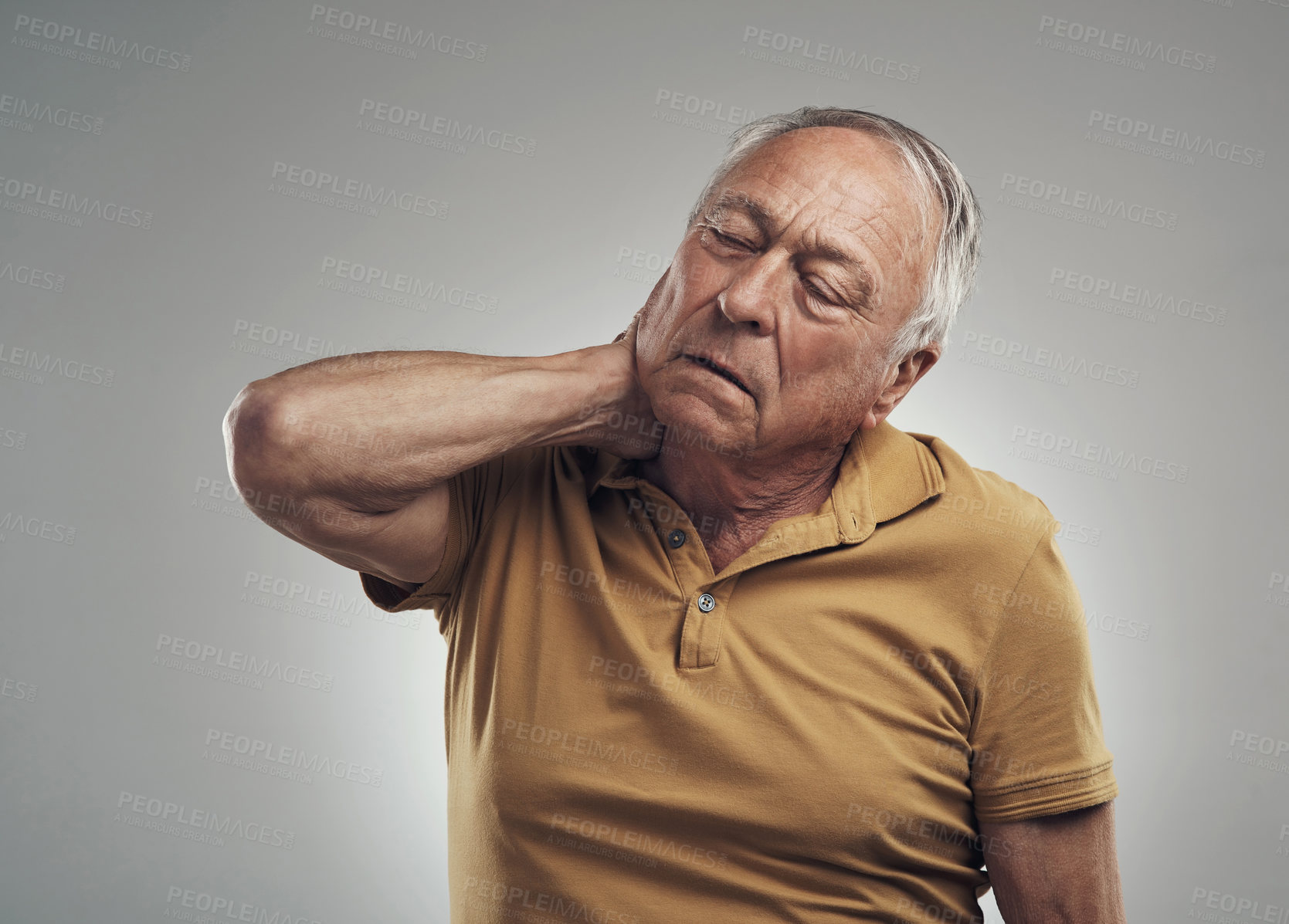 Buy stock photo Studio shot of an elderly man experiencing some pain against a grey background