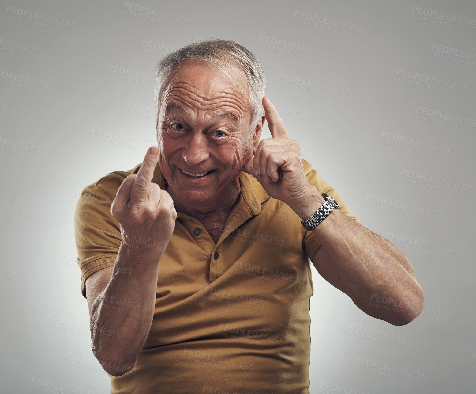 Buy stock photo Studio shot of an elderly man showing his middle finger against a grey background