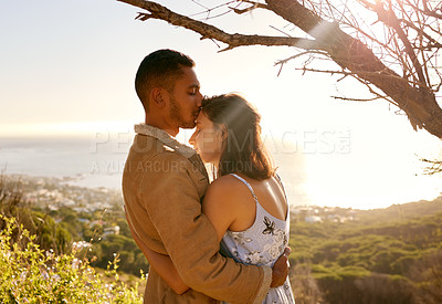 Buy stock photo Shot of a young couple embracing one another on a date outside in nature