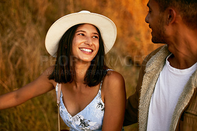 Buy stock photo Shot of a young couple enjoying the sunset walk with outside in nature