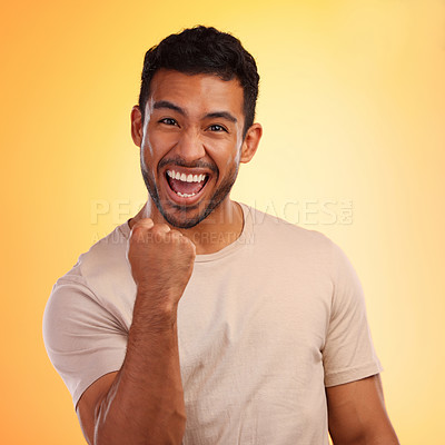 Buy stock photo Shot of a young man looking cheerful while standing against a yellow background