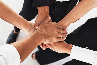 Buy stock photo Closeup shot of a group of unrecognisable businesspeople joining their hands together in a huddle
