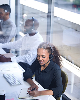 Buy stock photo Call center, customer support with a happy black woman consultant working in her telemarketing office. Contact us, crm and communication with a female consulting using a headset from above