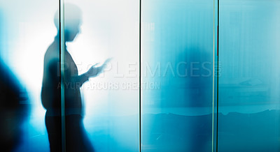 Buy stock photo Glass wall, email and businessman reading on a phone for contact, communication and work. Silhouette, social media and employee typing on a mobile chat with news, information and app for work