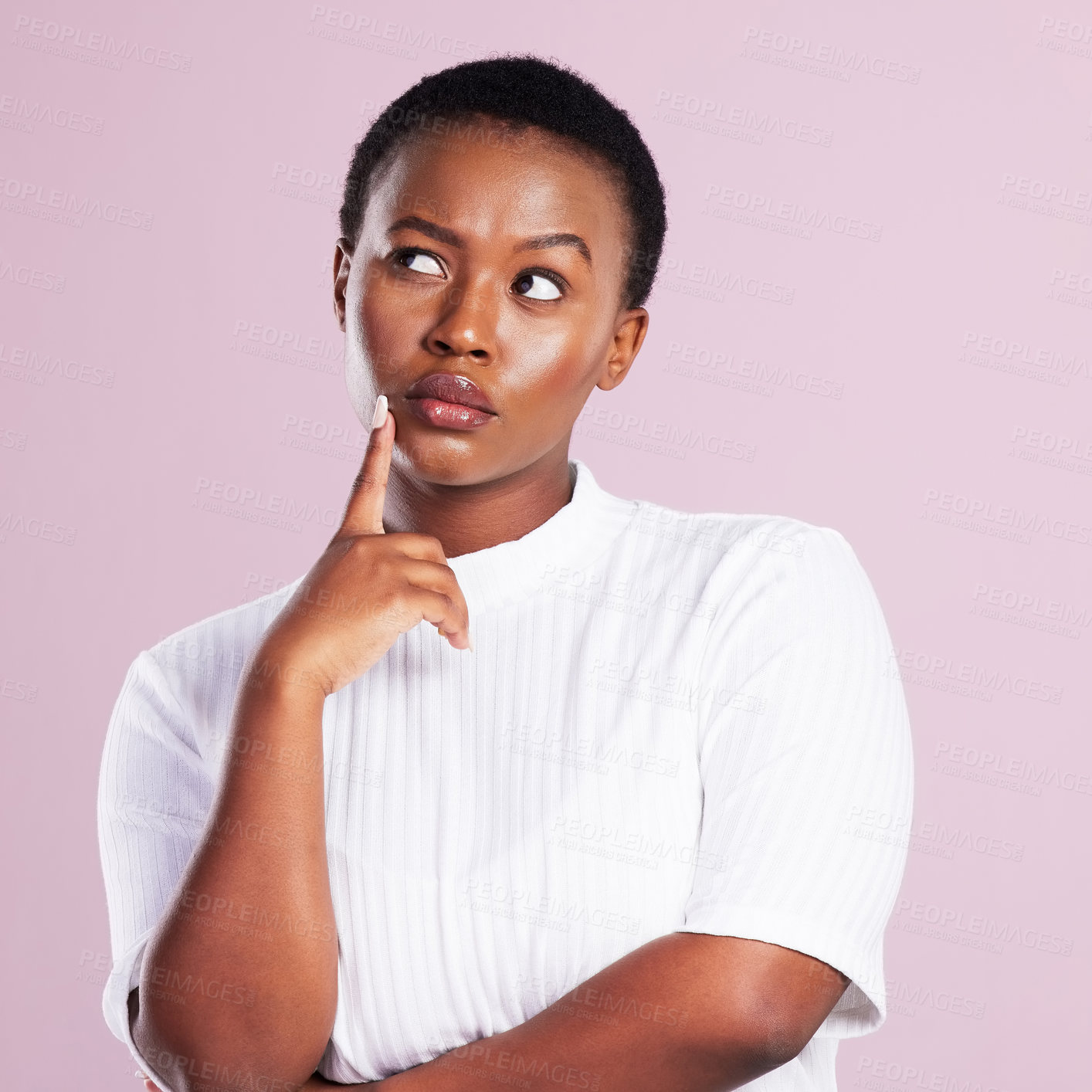 Buy stock photo Studio shot of a young woman looking contemplative against a pink background