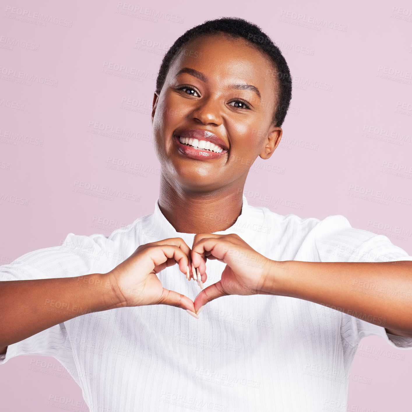 Buy stock photo Black woman, portrait and heart hand sign for love with a smile with happy university student in studio. Emoji, care and excited gesture with casual fashion with pink background for valentines day