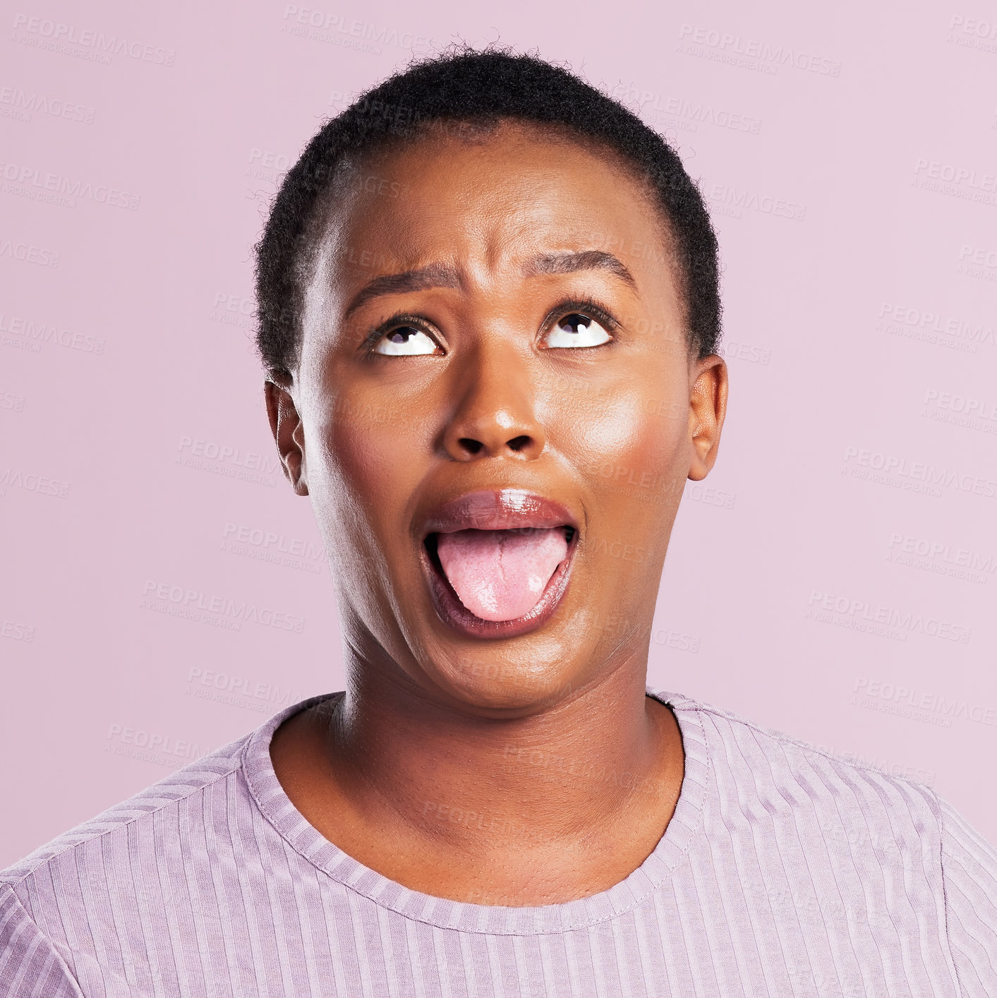 Buy stock photo Black woman, face and tongue out in studio with funny for comic meme, silly comedy and eye roll. African girl, pink background and crazy emoji with mouth for weird expression and wild or goofy person