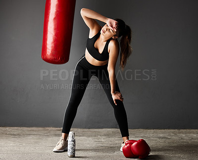 Buy stock photo Punching bag, tired boxer or woman on break in boxing training, exercise or workout in gym studio. Sweating, sports athlete or exhausted girl with fatigue, fitness or water bottle on grey background