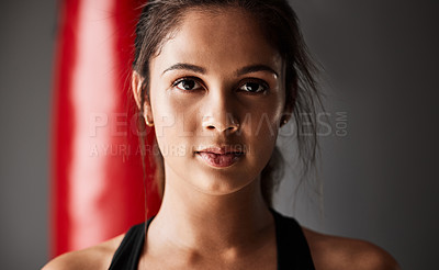 Buy stock photo Punching bag, athlete or portrait of woman in boxing training, exercise or workout in gym studio for wellness. Ready, boxer or face of strong girl with confidence, fitness or power on grey background