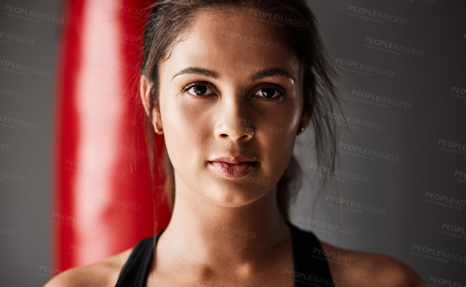 Buy stock photo Punching bag, athlete or portrait of woman in boxing training, exercise or workout in gym studio for wellness. Ready, boxer or face of strong girl with confidence, fitness or power on grey background