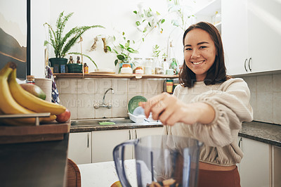 Buy stock photo Shot of a young woman using her blender to make a smoothie