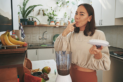 Buy stock photo Shot of a young woman tasting her smoothie