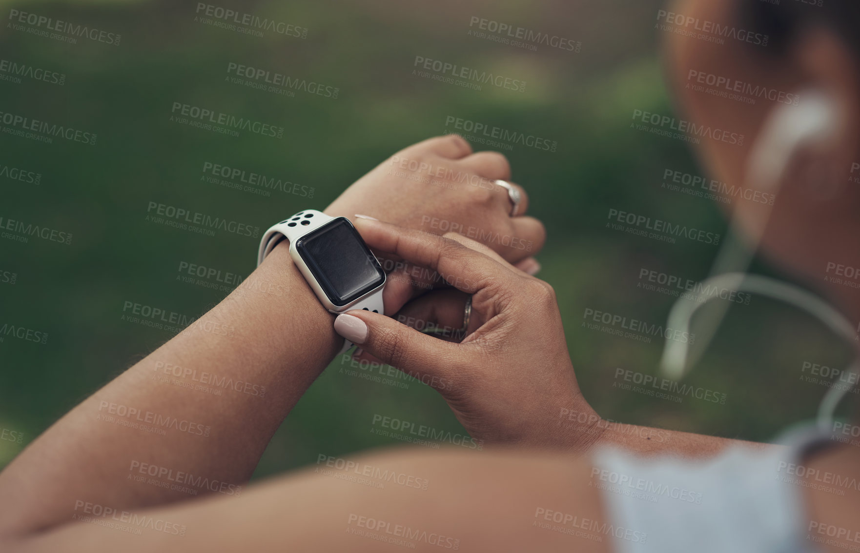 Buy stock photo Shot of a woman using her smartwatch during a workout