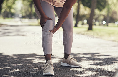 Buy stock photo Shot of a woman massaging an injury in her leg