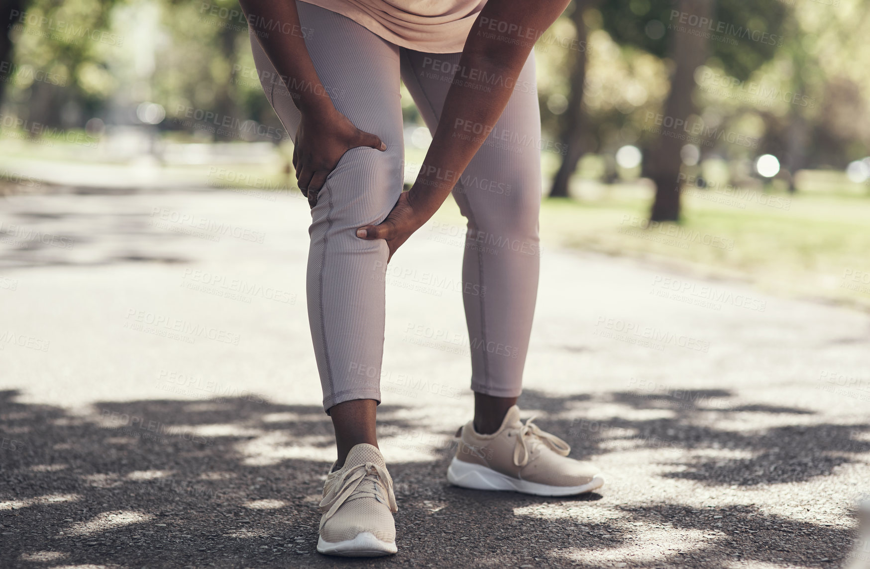 Buy stock photo Shot of a woman massaging an injury in her leg