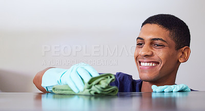 Buy stock photo Young man, smile and cleaning a kitchen counter, housekeeping and disinfecting surface with cloth. Gloves, safety and wipe furniture with rag for hygiene, house work and domestic chores at home