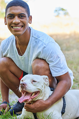 Buy stock photo Young man, portrait and dog on lawn with happiness, playing with pitbull for pet love and fun outdoor. Adoption, foster and bonding in park with animal for friendship, puppy and care free in nature