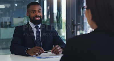 Buy stock photo Shot of a young businessman having a meeting with a colleague in an office