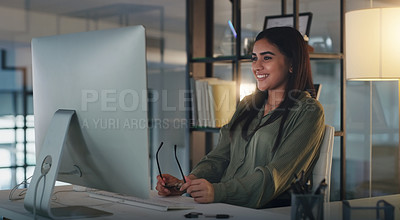 Buy stock photo Night, reading and woman with computer in office for online creative research for copywriting deadline. Technology, smile and female writer working late on internet with desktop in workplace.