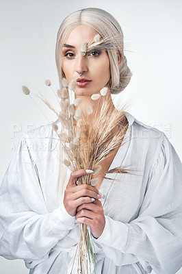 Buy stock photo Studio shot of an attractive young woman posing against a white background