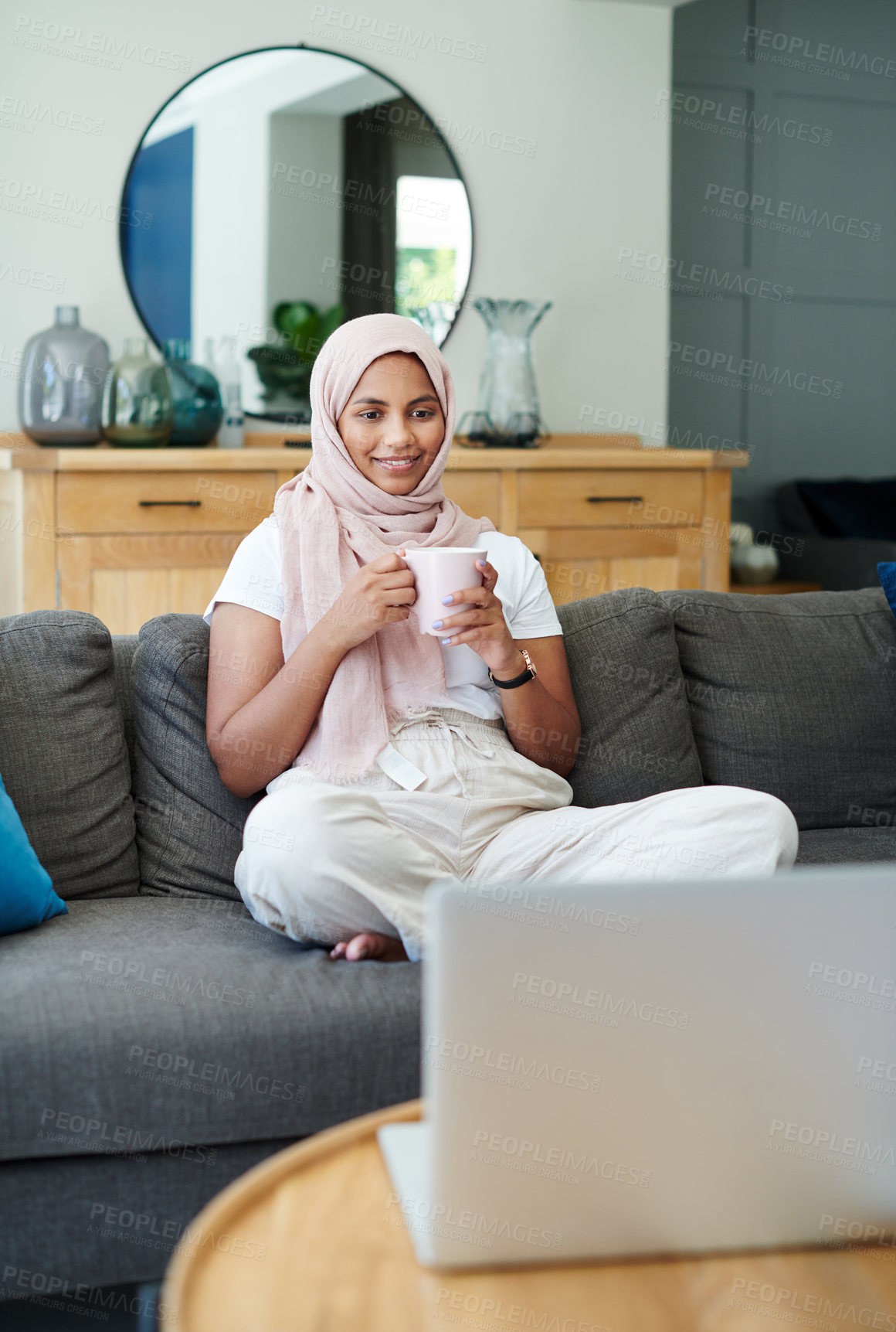 Buy stock photo Remote work, sofa and Muslim woman on laptop with coffee for online project, job and research. Working from home, business and person with tech for website, internet and planning for freelance career