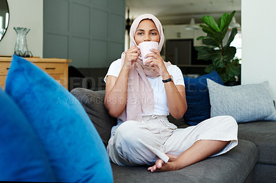 Buy stock photo Portrait, woman and drink on sofa in morning for daily routine in living room for ramadan. Female person, relax and hijab for muslim or islam religion in home on couch with caffeine or coffee.