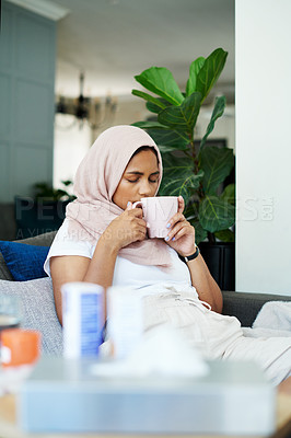 Buy stock photo Muslim woman, sick and smelling herbal tea for natural aroma, healing and relax in living room. Female person, hijab and mug with thinking for flu infection, illness recovery and treatment in winter