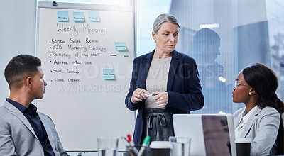 Buy stock photo Shot of a mature businesswoman giving a presentation to her colleagues in an office