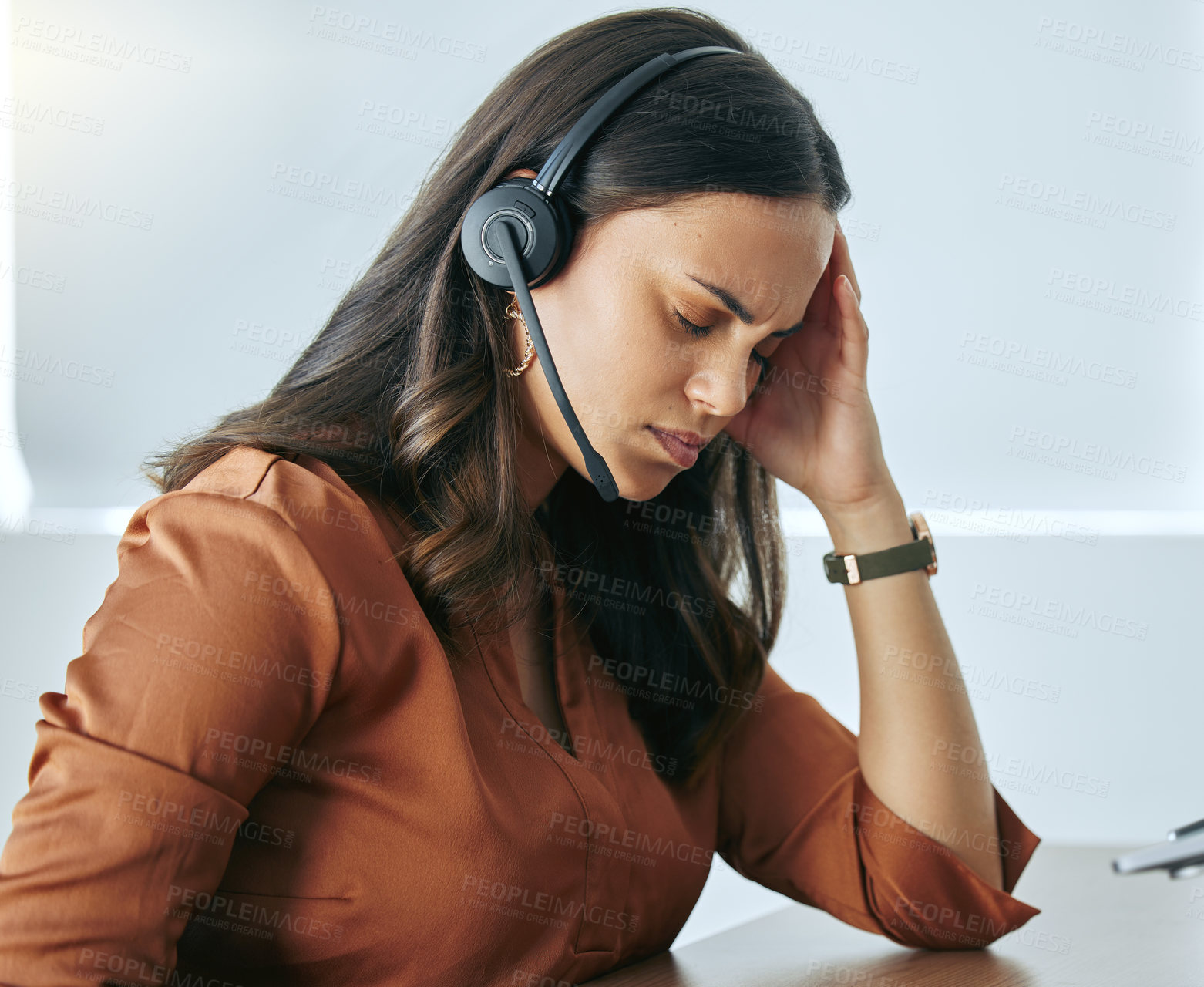 Buy stock photo Mental health, woman with headset and headache at desk at her office at workplace with a lens flare. Stress or burnout, sad and female person at call center or telemarketing with migraine pain