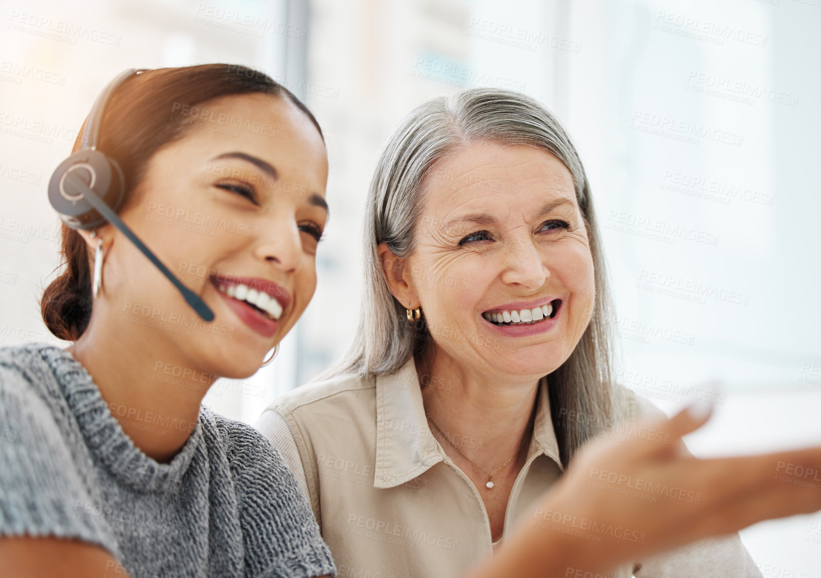 Buy stock photo Shot of an attractive young call centre agent sitting in the office and getting help from her manager