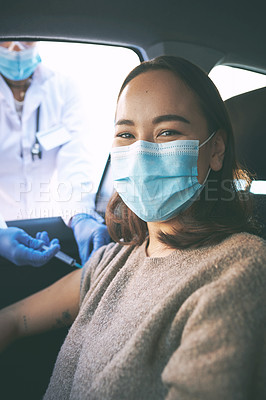 Buy stock photo Shot of a masked young woman receiving an injection at a Covid-19 drive through testing centre