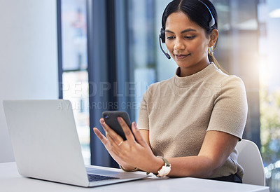 Buy stock photo Call center, woman and typing on smartphone at laptop in office of customer service, CRM consulting and help desk. Telemarketing, female consultant and mobile communication at computer on telecom app