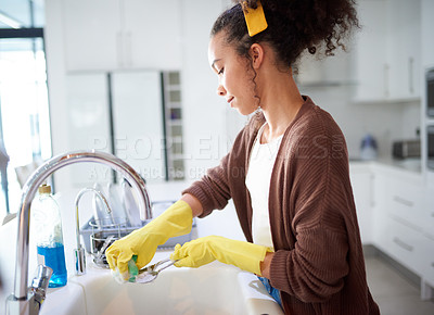 Buy stock photo Woman washing dishes in kitchen, cleaning and housework with hygiene, housekeeping and domestic routine. Female cleaner at home, housekeeper clean dirty spoon with sponge and rubber gloves for safety