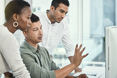 Buy stock photo Shot of three colleagues having a discussion in a modern office
