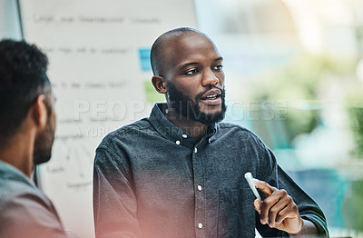Buy stock photo Planning, black man in a business meeting with his colleague in a office at work. Teamwork, collaboration and communication with coach and people brainstorming together at their workplace